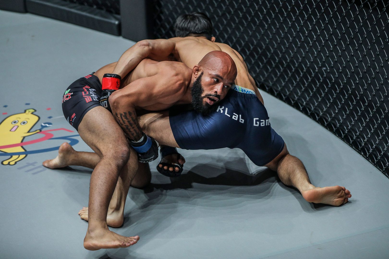 Demetrious Johnson attempts a takedown during an MMA fight, showcasing grappling technique often seen in the greatest MMA submissions, including iconic UFC submissions, legendary MMA submissions, and jiu-jitsu submissions in MMA that lead to historic UFC tapouts and best tap-out wins.