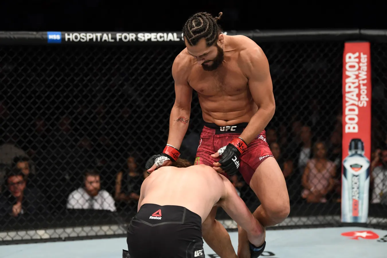 Jorge Masvidal delivers a flying knee strike to Ben Askren during their UFC 239 fight, leading to the fastest knockout in UFC history.