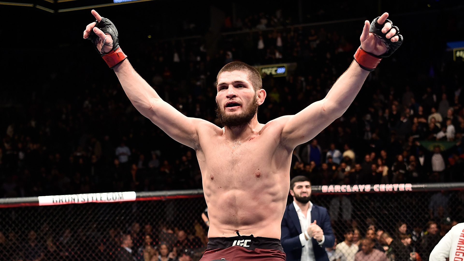 An MMA Lightweight Champion raising his arms in victory inside the octagon, representing the UFC Lightweight Champions among the Top 10 UFC Champions in the UFC Lightweight Division, celebrating an unforgettable moment in UFC Title Reigns.